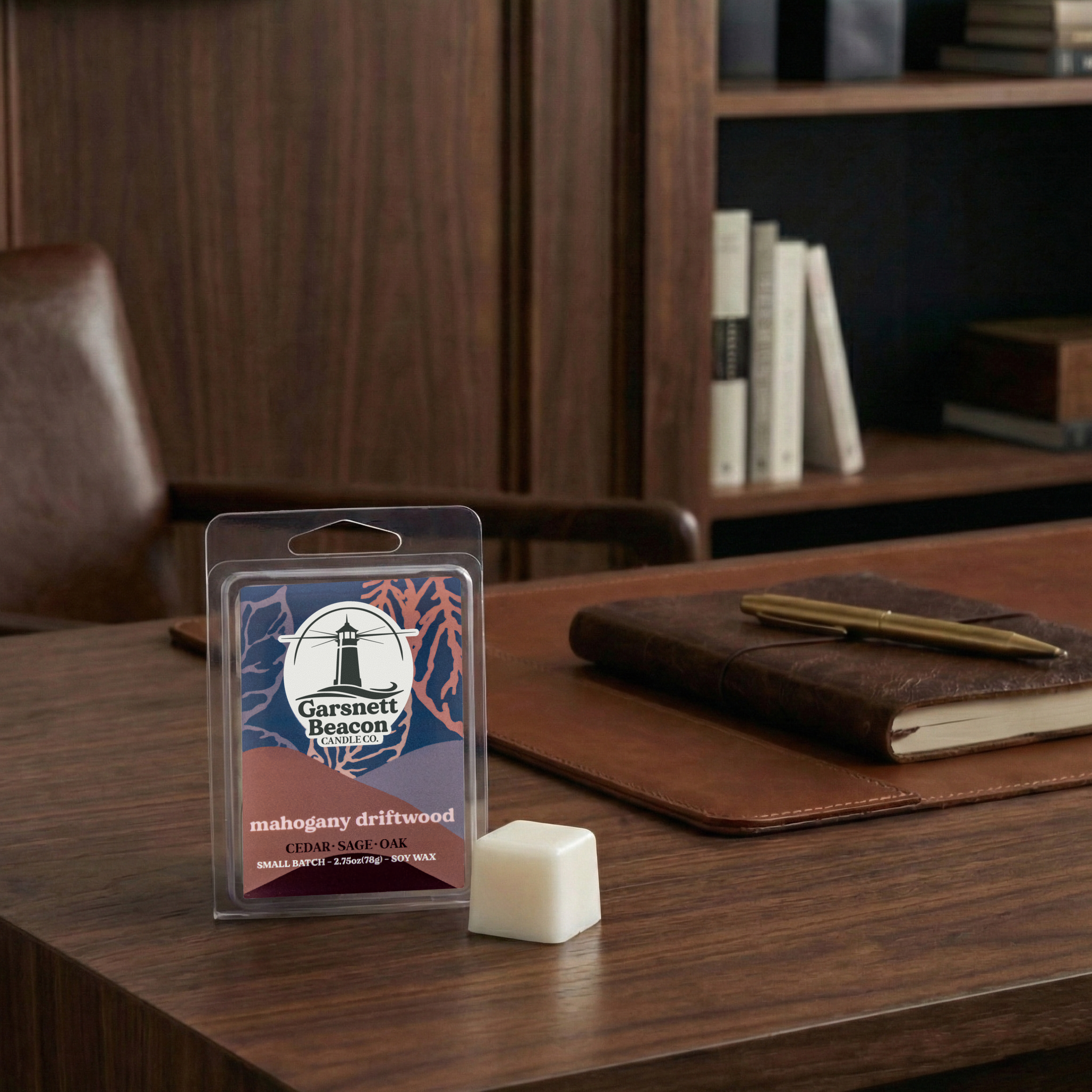 Garsnett Beacon Mahogany Driftwood wax melt packaging on a wooden surface with a notebook and pen.