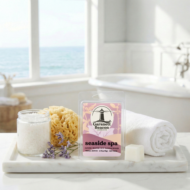Seaside Spa Wax melts labeled 'Garsnett Beacon' on a tray with a sponge, jar, and towel in a bright room.