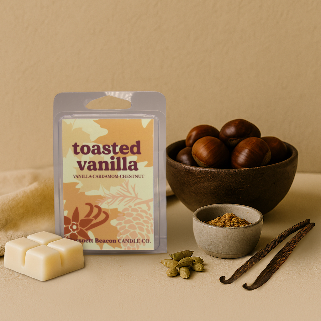 Scented wax melt 'Toasted Vanilla' with chestnuts, vanilla beans, and a bowl of spices on a beige background.