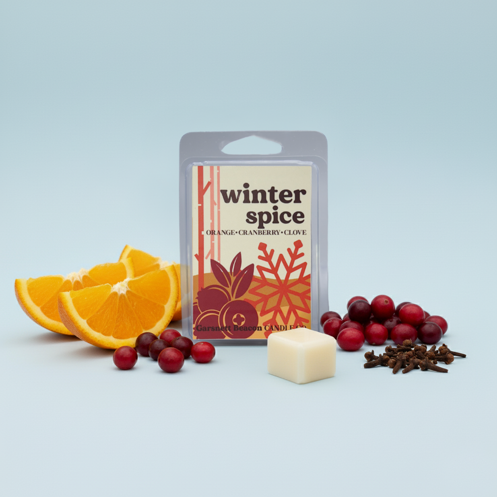 Winter spice wax melt with orange slices, cranberries, and cloves on a light blue background