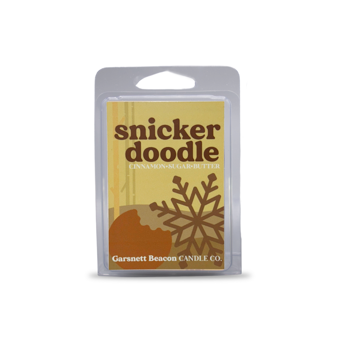 Snickerdoodle-themed wax melt with cookies, cinnamon, and a wax bar on a light blue background