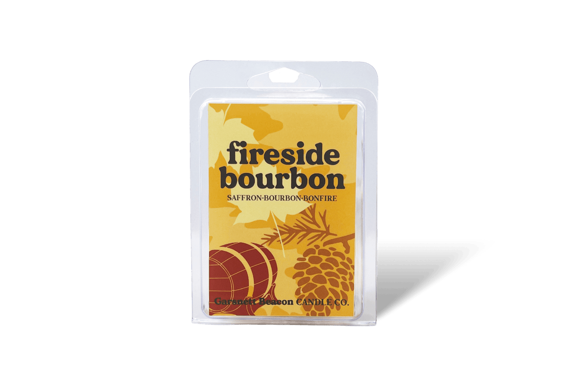 Fireside bourbon wax melt packaging with saffron, cinnamon sticks, and wood on a beige background